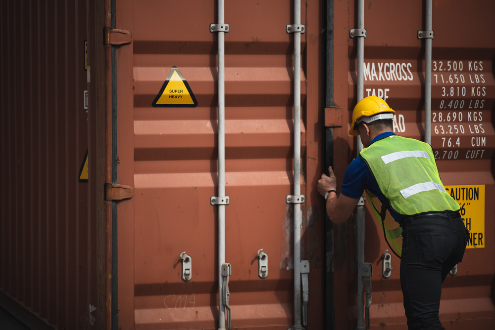 Person inspecting shipping container before purchase